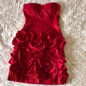 Red strapless dress with roses at the bottom.
